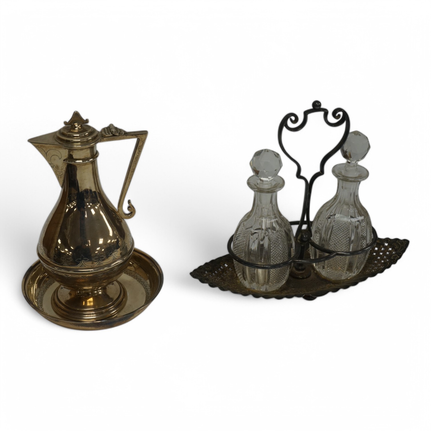 An Edwardian silver communion jug, by James Deakin & Sons, London, 1908, 15.2cm, together with a late Victorian repousse silver cruet stand with two glass bottles and stoppers, James Dixon & Sons, Sheffield, 1897 and a c